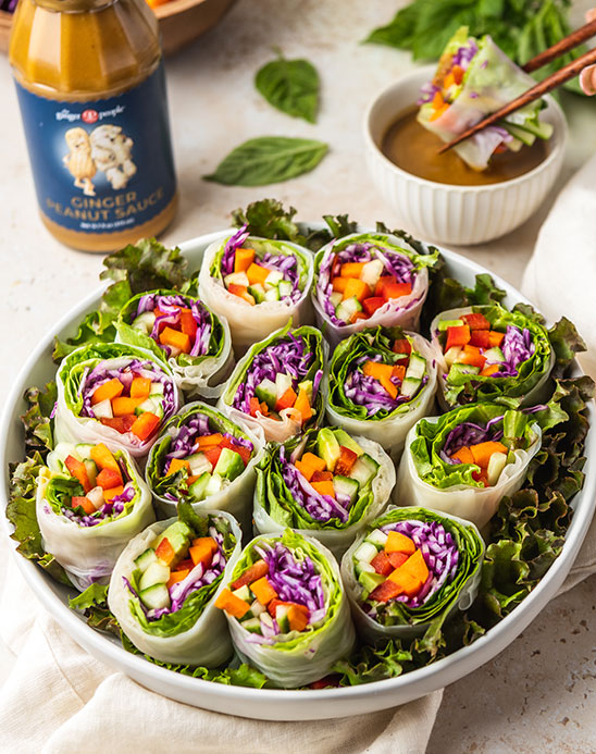 https://gingerpeople.com/wp-content/uploads/2022/08/Vegetable-Spring-Rolls-with-Ginger-Peanut-Sauce-main-image.jpg